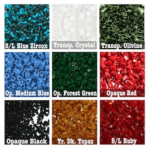 May include: A collection of seed beads in various colors and finishes, including opaque, transparent, and metallic. The beads are arranged in a grid pattern, with each color and finish labeled below. The colors include blue zircon, crystal, olivine, medium blue, forest green, red, black, topaz, and ruby.