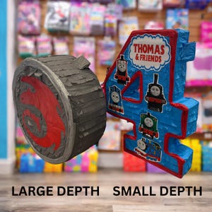 May include: A blue number 4 pi&ntilde;ata with red trim and Thomas & Friends characters. Beside it is a gray wheel pi&ntilde;ata with a red design. The pi&ntilde;atas are for a birthday party.