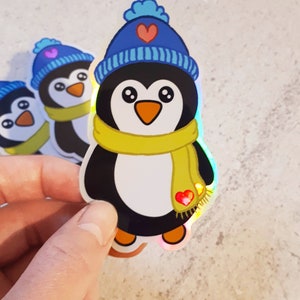 Lindo pingüino con bufanda y gorro