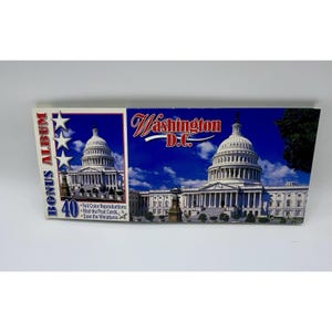 May include: A souvenir album featuring the U.S. Capitol Building in Washington, D.C. The album has a blue and white design with the words "BONUS ALBUM" and "40" printed on the front. The album also includes the text "Full Color Reproductions, Mail the Post Cards, Save the Miniatures."