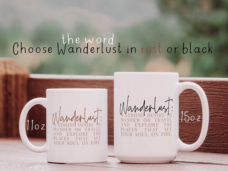 May include: Two white ceramic mugs with the word "Wanderlust" in black script and a definition of the word in rust colored text. The mugs are 11 oz and 15 oz.