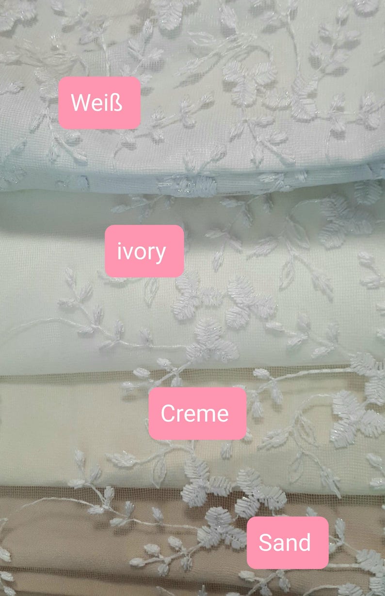 May include: Close-up of several fabric swatches in various shades of white, cream, and sand. Each swatch features an embroidered floral design. The swatches are labeled with the colors: Wei&szlig;, ivory, Creme, and Sand.