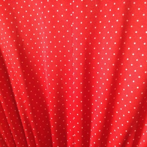 May include: Red fabric with a white polka dot pattern.