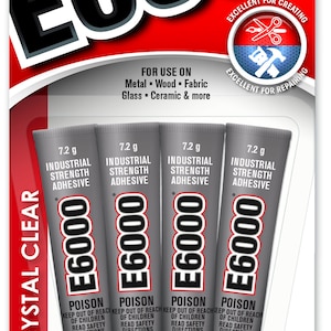 May include: A pack of four 7.2 gram tubes of E6000 industrial strength adhesive, crystal clear, for use on metal, wood, fabric, glass, ceramic, and more. The packaging is red and white with the text "E6000" in large black letters. The product is made in the USA by Eclectic Products.