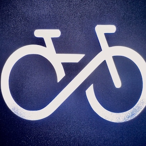 May include: White silhouette of a bicycle on a dark blue background.