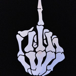 May include: A white skeletal hand giving the middle finger. The hand is outlined in white against a black background.