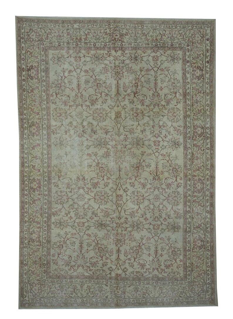 May include: Rectangular area rug with an intricate floral pattern in shades of beige and burgundy. The rug features a detailed border and a central field filled with stylized flowers and foliage, creating a classic, elegant design.