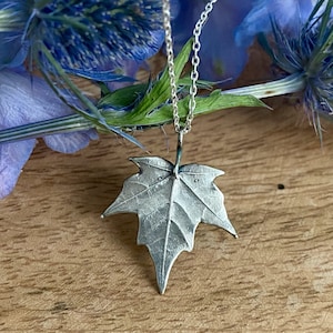 Dainty maple leaf pendant in silver, Realistic botanical jewelry with leaf motif, Eye-catching nature-inspired necklace with silver chain