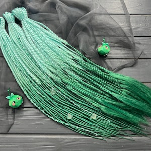 Synthetic dreadlocks thin twisted + fishtail braids ombre mint on a green bandage and shell beads as a gift hair extensions