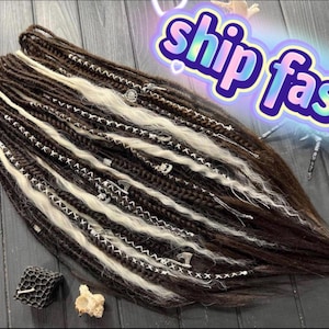 May include: A set of dark brown and white synthetic dreadlocks featuring braided sections, loose wavy strands, and silver-toned metal charms. The text "ship fast" is displayed in a blue and purple gradient font with a white outline.