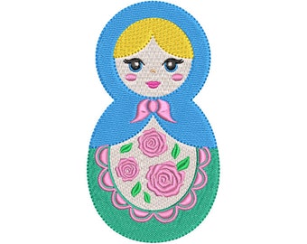 May include: A blue and green embroidered Russian nesting doll with a pink bow and floral design.