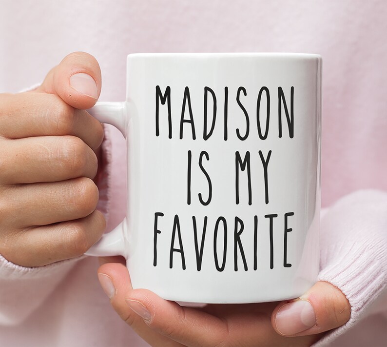 May include: White ceramic mug with black text that reads "MADISON IS MY FAVORITE".