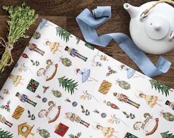 May include: White wrapping paper with a repeating pattern of nutcrackers, ballerinas, rocking horses, Christmas trees, holly, and ornaments. The pattern is in shades of red, green, blue, gold, and white.