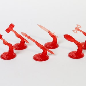 May include: Six red plastic miniature weapon stands with different weapons, including a hammer, a sword, an axe, and a spear. The stands are designed to hold miniature figures.