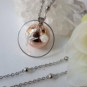 Moonstone rimmed pregnancy bola, rose gold plated musical ball, hummingbird and stainless steel chain