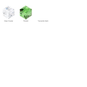 May include: Three clear glass cubes, each with a different colour: clear crystal, peridot green, and tanzanite satin.