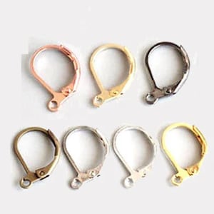 May include: Eight earring hooks in different metal finishes: gold, silver, rose gold, and black. The hooks are all the same size and shape, with a small loop at the top and a curved wire that forms a hook.