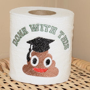 May include: A white toilet paper roll with a brown poop emoji wearing a graduation cap. The text "Done with this" is embroidered around the emoji.