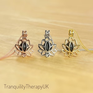 May include: Three lotus flower shaped essential oil diffusers with black lava rock inside. The diffusers are silver, gold, and rose gold.