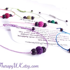 May include: Five colorful bracelets with lava beads and black beads. The bracelets are made with a knotted cord. A card with the text "Aromatherapy Diffuser" is visible in the image.