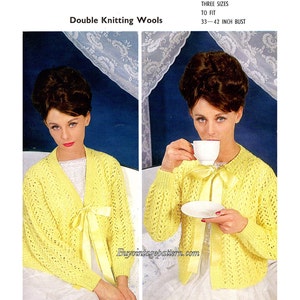 May include: A vintage knitting pattern featuring a yellow cardigan with a tie at the neckline. The pattern is for sizes 33 to 42 inch bust. The text "Double Knitting Wools" and "Three Sizes To Fit 33-42 Inch Bust" is visible in the image.