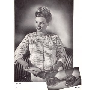 May include: A vintage crochet cardigan with a delicate openwork pattern and satin ribbon bows. The cardigan is shown being worn by a woman with a classic hairstyle. The image also includes a pair of crocheted slippers with a flower embellishment.