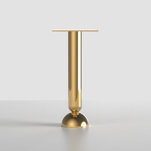 May include: A gold metal table leg with a round base and a square top.