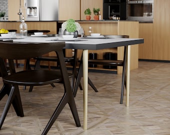May include: A modern dining table with a white top and gold metal legs. The table is set with four chairs and has a minimalist design.