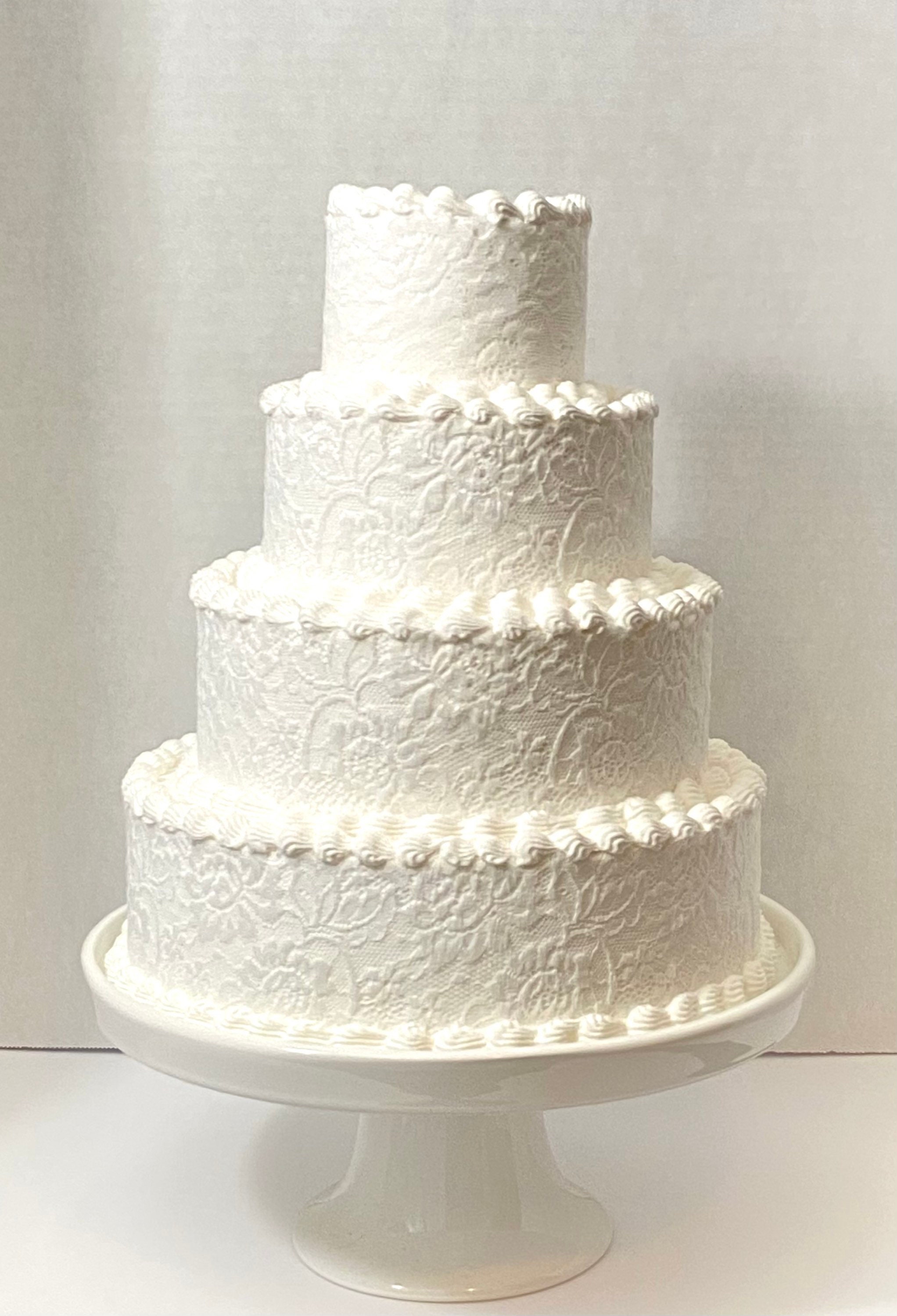 White lace 4 tiered fake cake, 10 inches wide, 12.5 inches tall, fake wedding cake