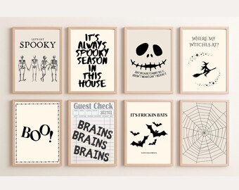 May include: A set of eight rectangular wall art prints in light wood frames featuring black and white Halloween designs. The prints include skeletons, text like 'It's Always Spooky Season', a pumpkin face, a witch, 'BOO!', 'Brains', bats, and a spider web.