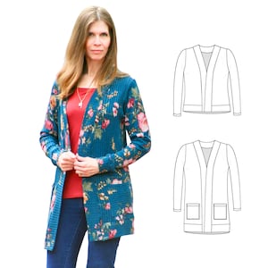 May include: A teal cardigan with a floral pattern featuring pink and red flowers. The long-sleeved sweater has a ribbed texture and two front pockets. The woman in the image is wearing a red top and blue jeans.