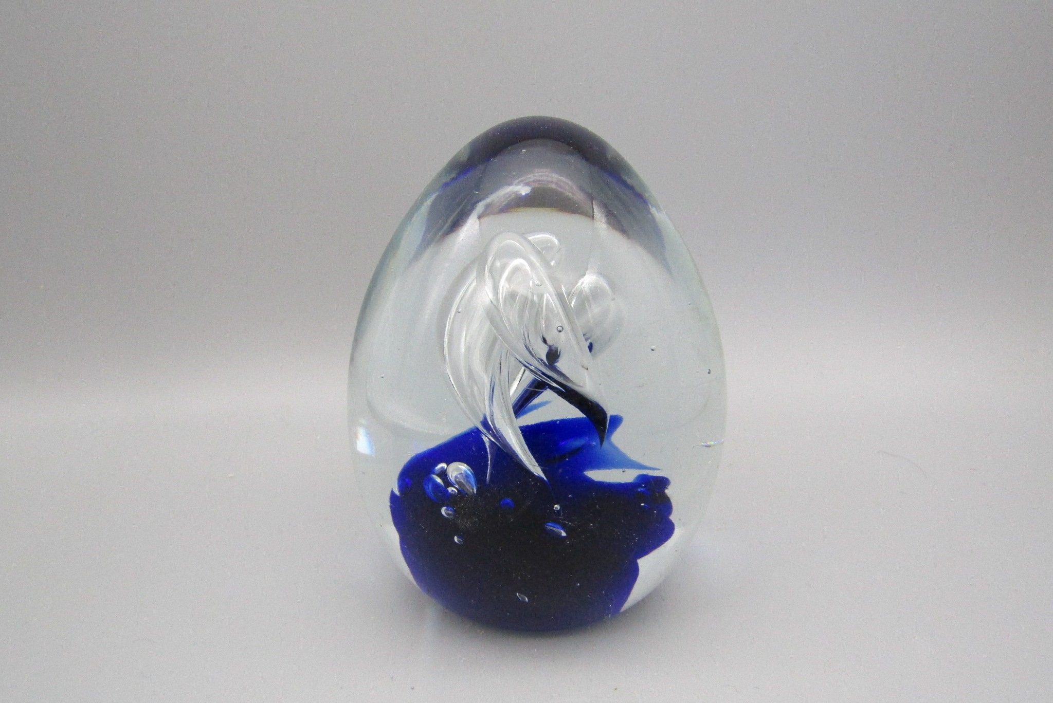 Cone shaped blue and clear glass paperweight