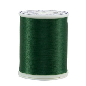 May include: A spool of dark green thread.