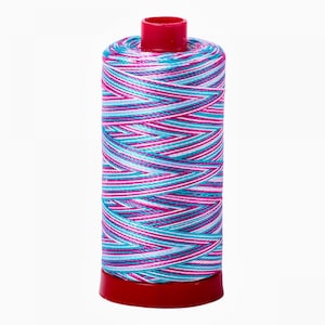 May include: A spool of colorful thread with a red plastic bobbin. The thread is a mix of white, pink, and blue stripes.