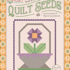May include: A rectangular product package titled Quilt Seeds by Lori Holt of Bee in my Bonnet, featuring a graphic illustration of a purple flower in a basket. The design includes the text Grow a Basketful of Quilty Flowers and Flower Basket No. 1.