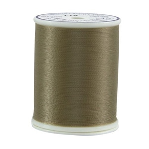 May include: A spool of brown thread with a white label that says "119" on it.