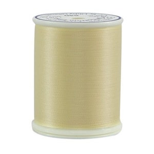 May include: A spool of cream-colored thread with a white label that reads "100% Cotton Embroidery Floss - 8.7 Yards - 40 Weight - Color 0000 - Cream".