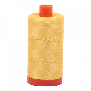 May include: A spool of yellow thread with an orange plastic bobbin.