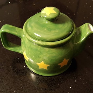 Cute little green teapot handpainted and decorated with yellow stars