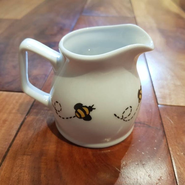 Cute little milk jug hand painted with gold and black bumble bees round the edge.