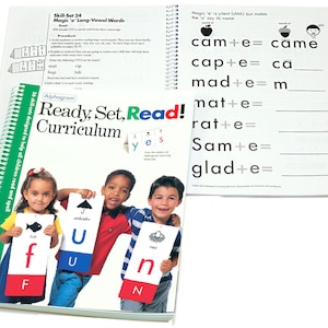 May include: A colorful educational book with the title "Ready, Set, Read! Curriculum" and a picture of three children holding colorful flashcards with letters and pictures. The book has a green spiral binding.
