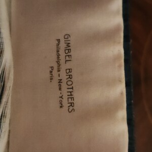 May include: A white tag with black text that reads "Gimbel Brothers Philadelphia - New York Paris."
