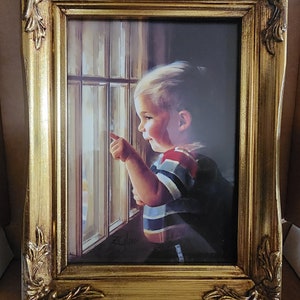 May include: A framed painting of a young child looking out a window. The child is wearing a striped shirt and pointing with their finger. The painting is in a gold frame with ornate details.