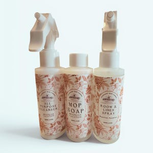 May include: Three white bottles of cleaning products with floral labels. The bottles are labeled "All Purpose Cleanser", "Mop Soap", and "Room & Linen Spray". Each bottle contains 4 fl oz (120 ml) of product. The products are from Pleasant Run Farms.