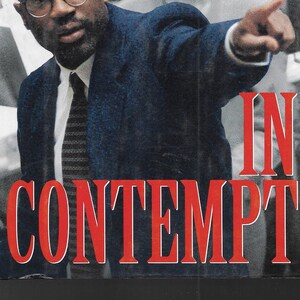 May include: Book cover with a black and white photo of a man in a suit and tie pointing his finger. The title of the book is "Christopher Darden with Jess Walter In Contempt".
