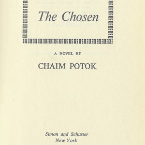May include: A title page from the book The Chosen by Chaim Potok, published by Simon and Schuster in New York. The text is printed in black ink on a cream-colored page, featuring a decorative rectangular border around the title.