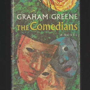 May include: Book cover for "The Comedians" by Graham Greene. The cover features three stylized masks in red, blue, and orange against a green and yellow background. The title and author's name are in white and yellow.