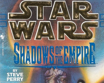 Pode incluir: Capa de livro de bolso de "Star Wars: Shadows of the Empire" de Steve Perry. A capa apresenta Darth Vader, Luke Skywalker e outros personagens. O título está em letras grandes e em negrito, com o texto "The New York Times Bestseller" no topo.