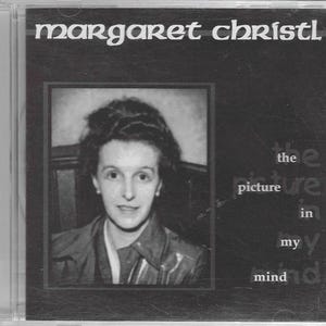 May include: Black and white photo of a woman with short, dark hair. The photo is in a frame and the text "the picture in my mind" is written below the photo.