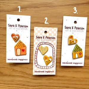 May include: Three handmade cards with illustrations. Each card features a different design: a house, two hearts, and a house with a heart. The cards are labeled with "Sara K Pearson ART & ILLUSTRATION" and "handmade happiness."